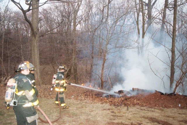 FF Wertz and FF/EMT Toader handle a brush fire on Wood Avenue on March 28, 2005.